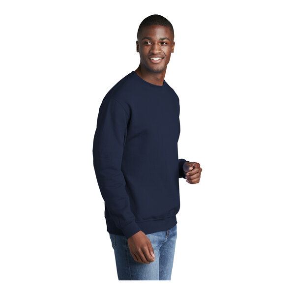 A man wearing a Port & Company navy core fleece sweatshirt and smiling.