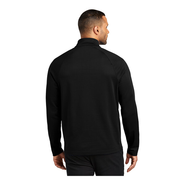 A man wearing a Port Authority black quarter-zip sweatshirt.