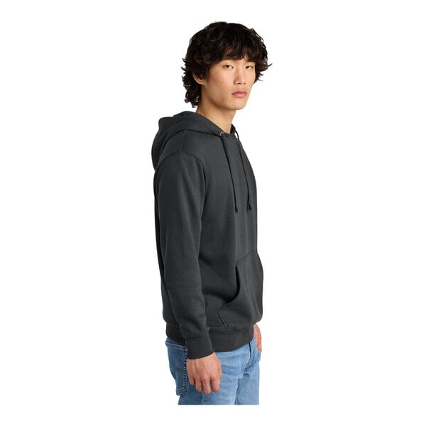 A man wearing a charcoal District hoodie.