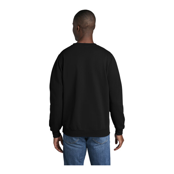 A man wearing a black Port & Company core fleece sweatshirt.