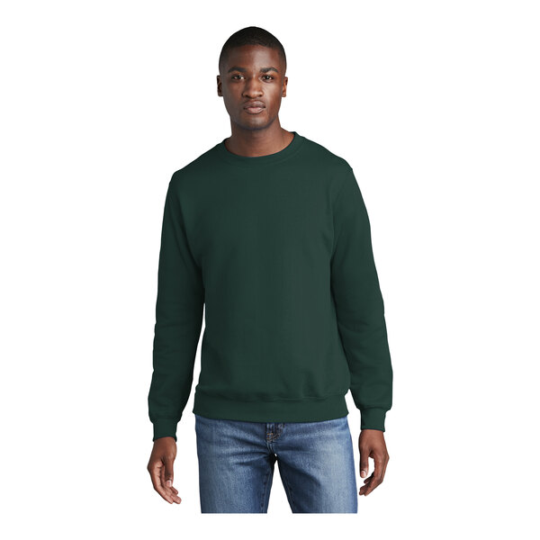 A man wearing a dark green Port & Company Core Fleece sweatshirt.