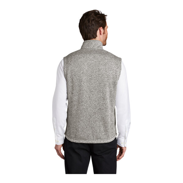 A man wearing a gray fleece sweater vest with a zipper.