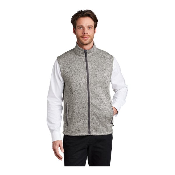 A man wearing a gray Port Authority fleece sweater vest.