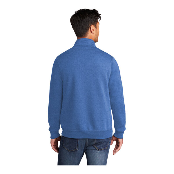 A man wearing a Port & Company heather royal quarter-zip pullover sweatshirt.