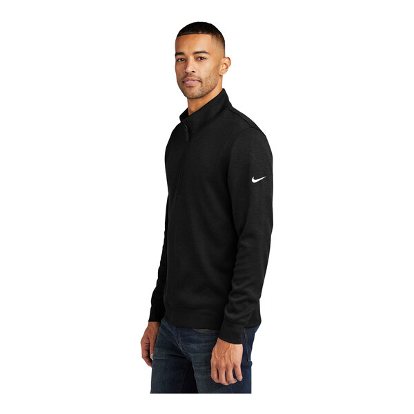 A man wearing a Nike black Dri-FIT 1/4 zip sweater.