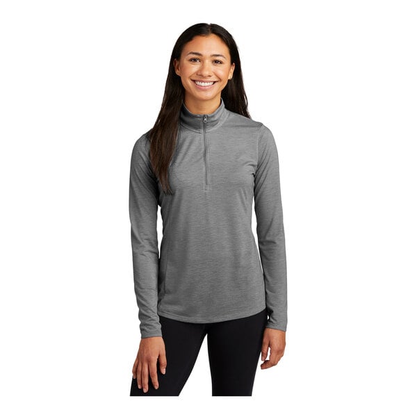 A woman wearing a Sport-Tek dark gray quarter-zip pullover.