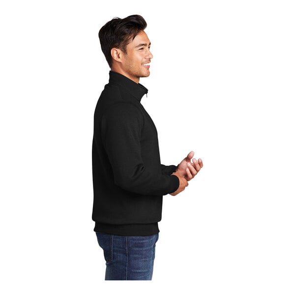 A man wearing a jet black Port & Company core fleece quarter-zip pullover.