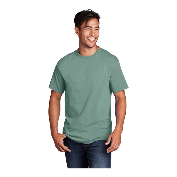 A man smiling and wearing a Port & Company laurel green short sleeve t-shirt.