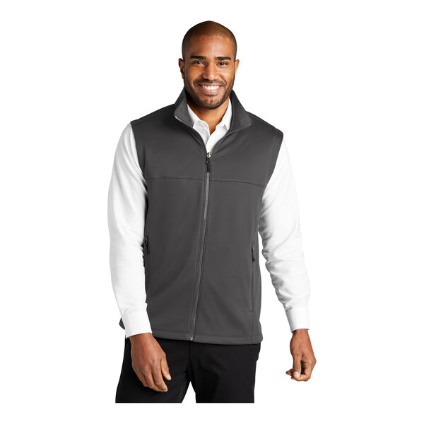 A man wearing a Port Authority graphite fleece vest.