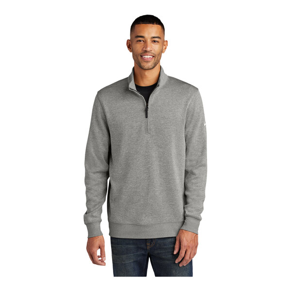 A man wearing a Nike gray Dri-FIT half-zip sweater.