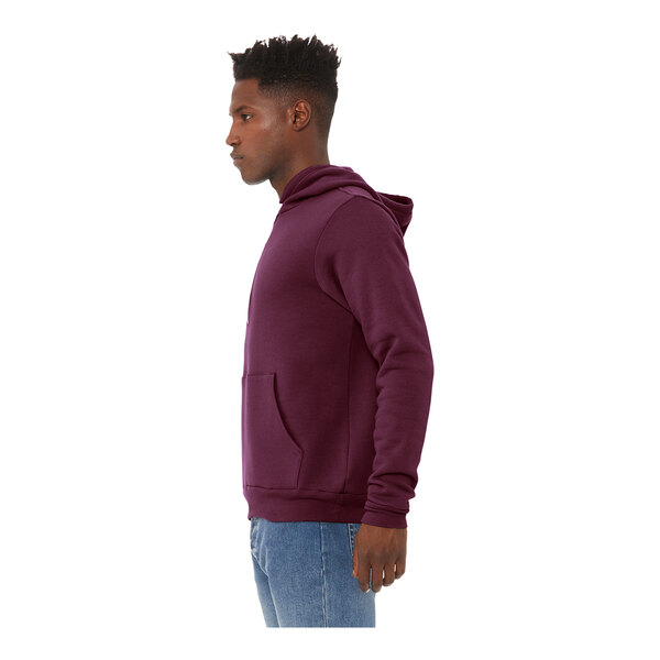 A man wearing a maroon Bella + Canvas sponge fleece pullover hoodie.
