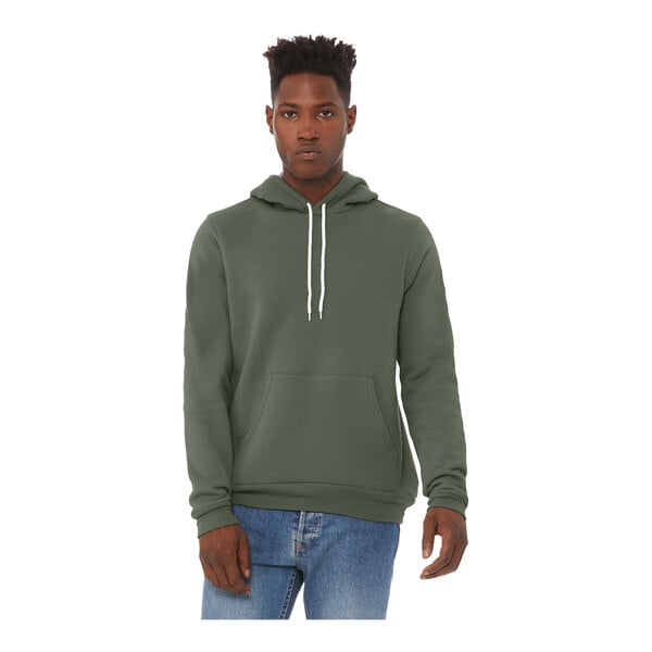 A man wearing a military green Bella + Canvas pullover hoodie.