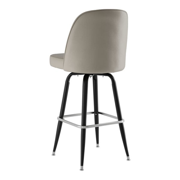 A Lancaster Table & Seating black swivel barstool with gray vinyl bucket seat.