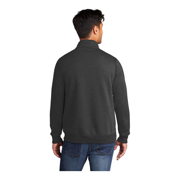 A man wearing a Port & Company dark heather gray quarter-zip pullover sweatshirt.