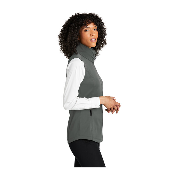 A woman wearing a Port Authority graphite smooth fleece vest.