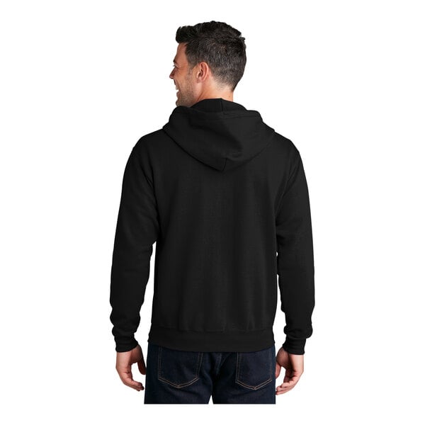 A man wearing a Port & Company black fleece full-zip hoodie.