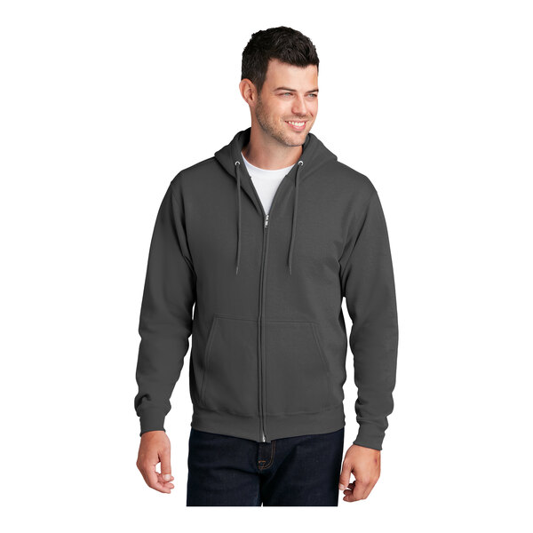 A man wearing a Port & Company charcoal full-zip hoodie.