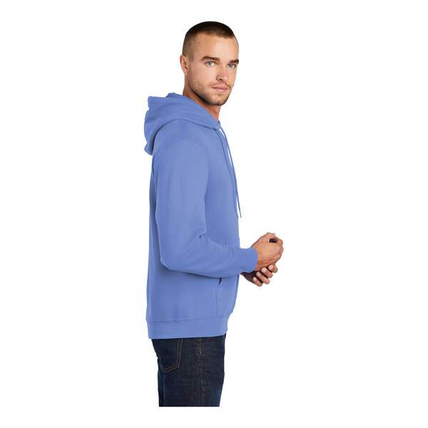 A man wearing a Carolina blue Port & Company Core Fleece hoodie.