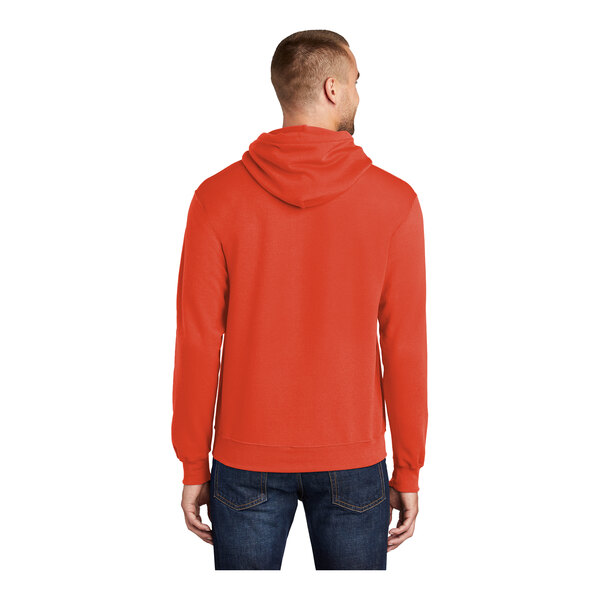 A man wearing an orange Port & Company Core Fleece pullover hoodie.