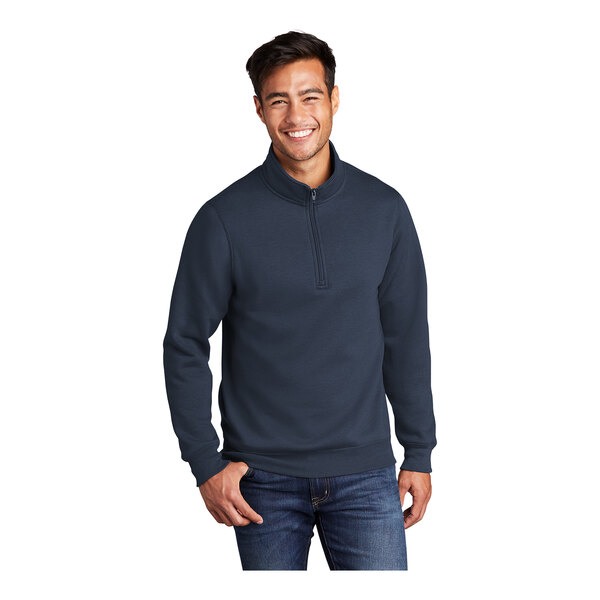 A man wearing a Port & Company navy quarter-zip pullover sweatshirt.