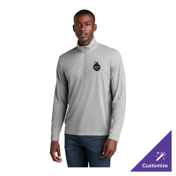 A light gray heather unisex quarter-zip pullover sweatshirt with a small chest logo, designed for moisture-wicking and customizable options.