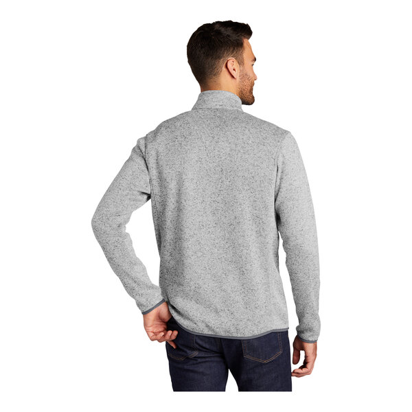 A man wearing a grey Port Authority fleece sweater jacket.