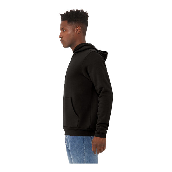 A man wearing a black Bella + Canvas sponge fleece pullover hoodie.