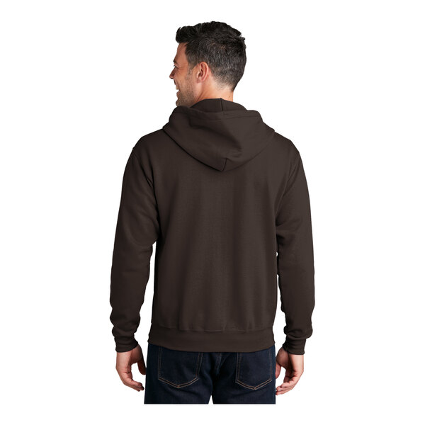 A man wearing a dark chocolate brown Port & Company full-zip hoodie.