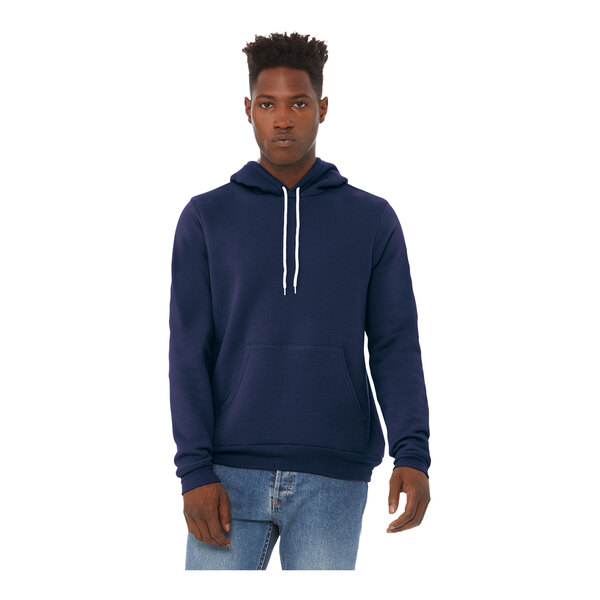 A man wearing a navy Bella + Canvas pullover hoodie.