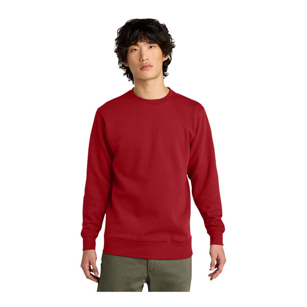 A man wearing a red District fleece sweatshirt.