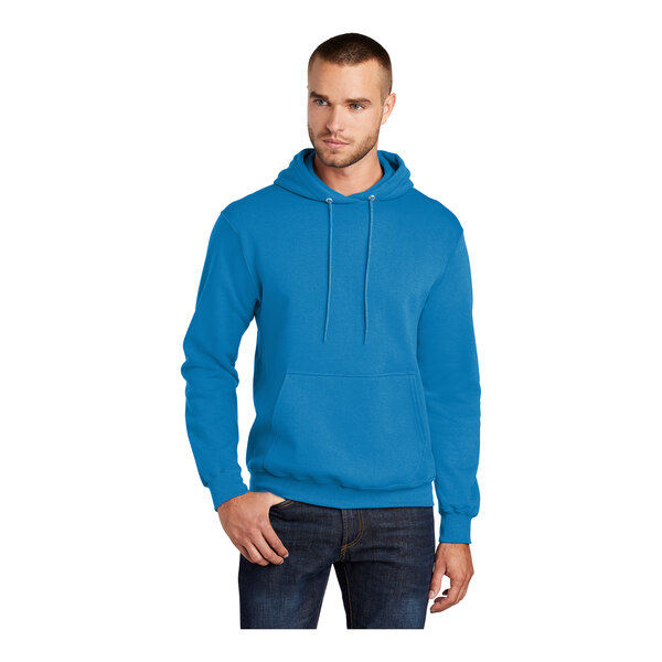 A man wearing a Port & Company blue fleece pullover hoodie.