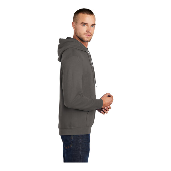 A man wearing a Port & Company charcoal fleece pullover hoodie.
