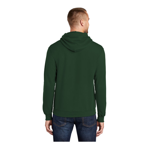 A man wearing a dark green Port & Company Core Fleece pullover hoodie.