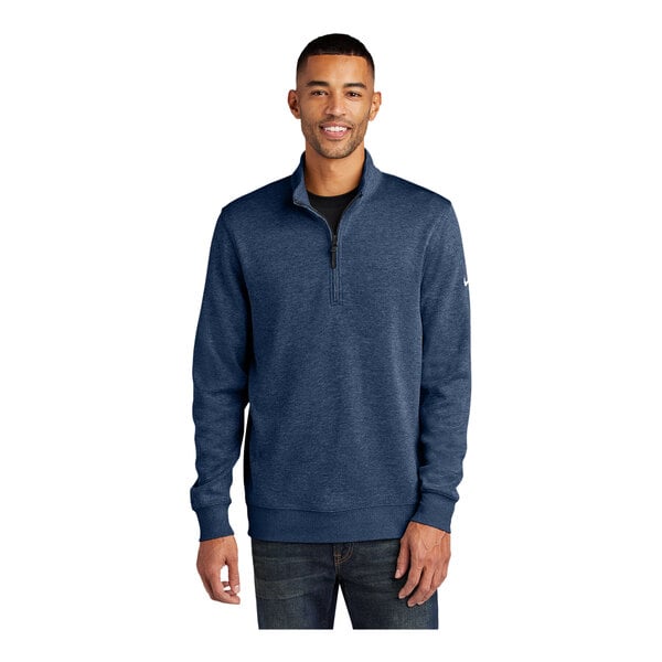 A man wearing a blue Nike Dri-FIT half-zip sweater.