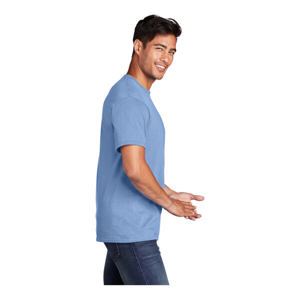 A man wearing a light blue Port & Company short sleeve T-shirt.