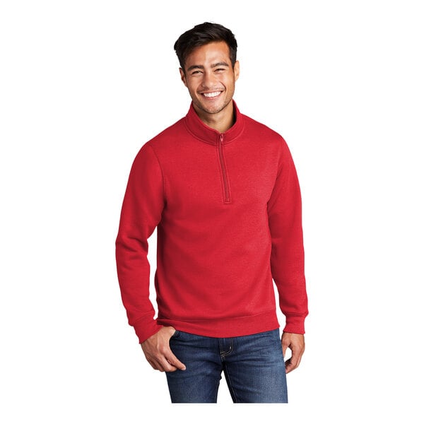 A man wearing a red Port & Company quarter-zip pullover.