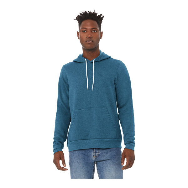 A man wearing a Bella + Canvas heather deep teal sponge fleece pullover hoodie.