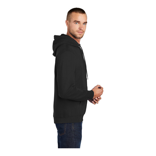 A man wearing a black Port & Company pullover hoodie.