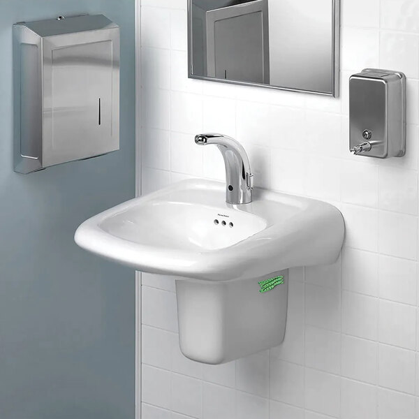 A white sink with a WizKid Cucumber Melon air freshener and soap dispenser.