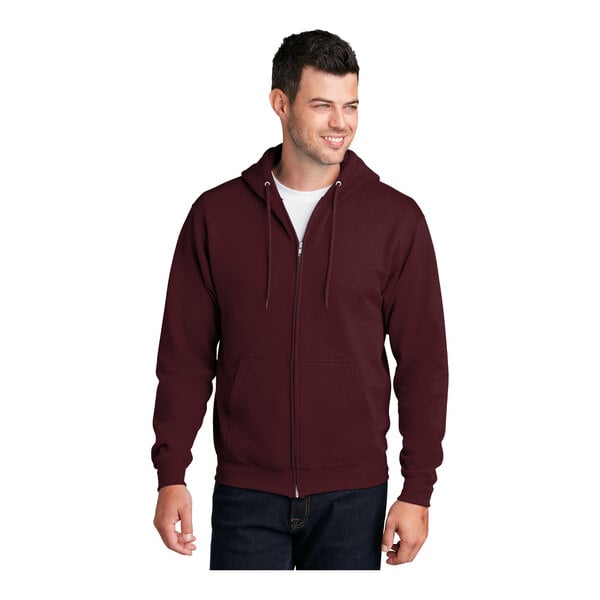 A man wearing a maroon Port & Company full-zip hooded sweatshirt.