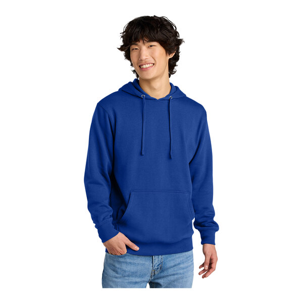 A man wearing a deep royal blue District hooded sweatshirt.