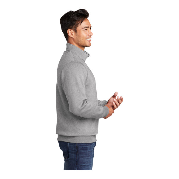 A man wearing a Port & Company Core Fleece quarter-zip pullover in athletic heather.