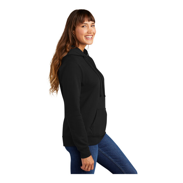 A woman in a Port & Company black core fleece pullover hoodie.