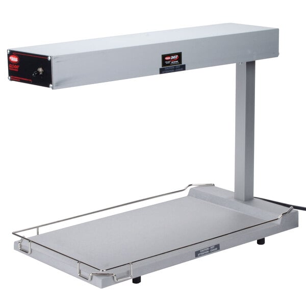 A grey rectangular Hatco food warmer with a black handle on a table.