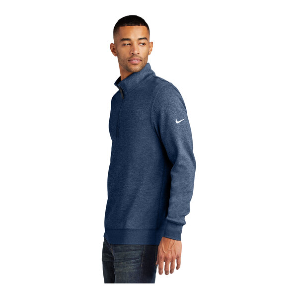 A man wearing a Nike navy blue Dri-FIT half-zip sweater.