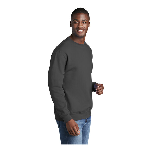 A man wearing a Port & Company charcoal crewneck sweatshirt.