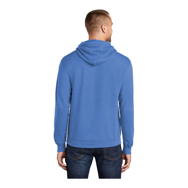 A man wearing a blue Port & Company Core Fleece pullover hoodie.