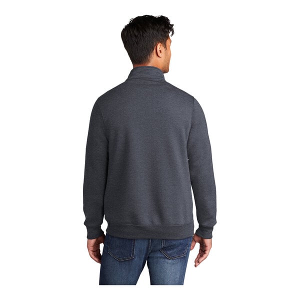 A man wearing a Port & Company heather navy quarter-zip sweatshirt.