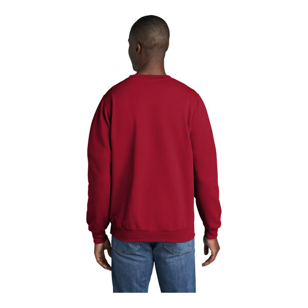 A man wearing a red Port & Company fleece sweatshirt.