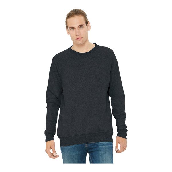 A man wearing a dark gray Bella + Canvas Sponge Fleece sweatshirt with black sleeves.